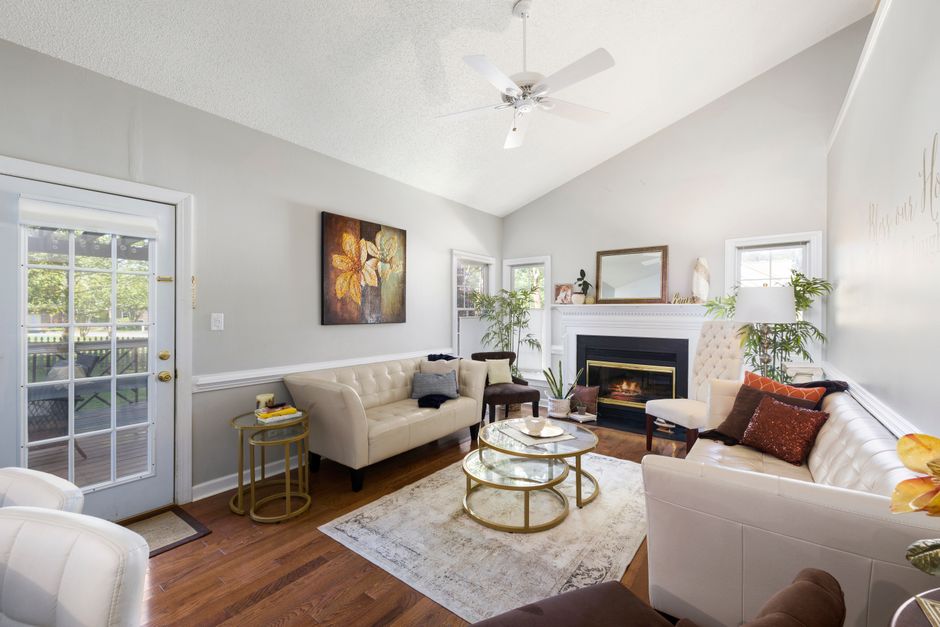 A bright, professionally staged modern living room with clean lines and neutral furniture, illustrating the investment in home staging to maximize a home's sale price.