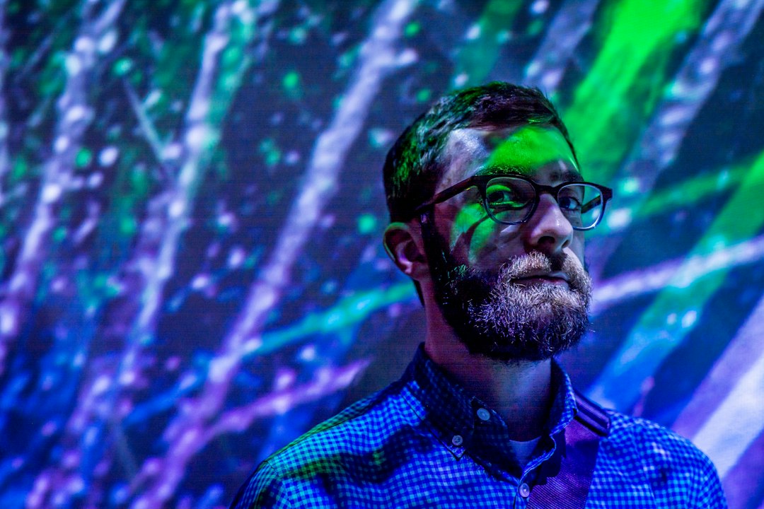 A CTO in a modern office thoughtfully analyzing complex data on a futuristic transparent screen, symbolizing strategic planning for the AI revolution.